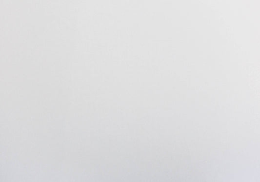 Flat lay of a crisp white linen tablecloth perfect for a minimalist dining setting