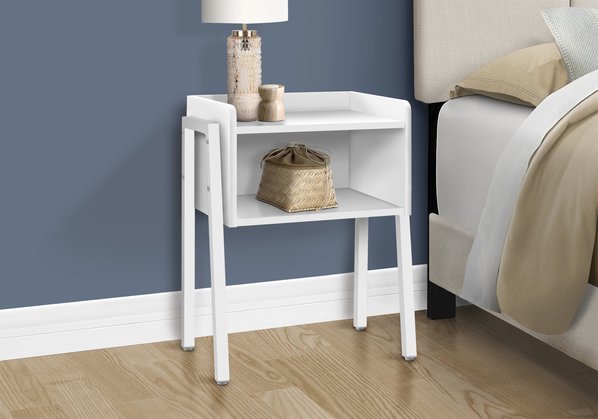Minimalist white metal nightstand with open shelves beside a bed