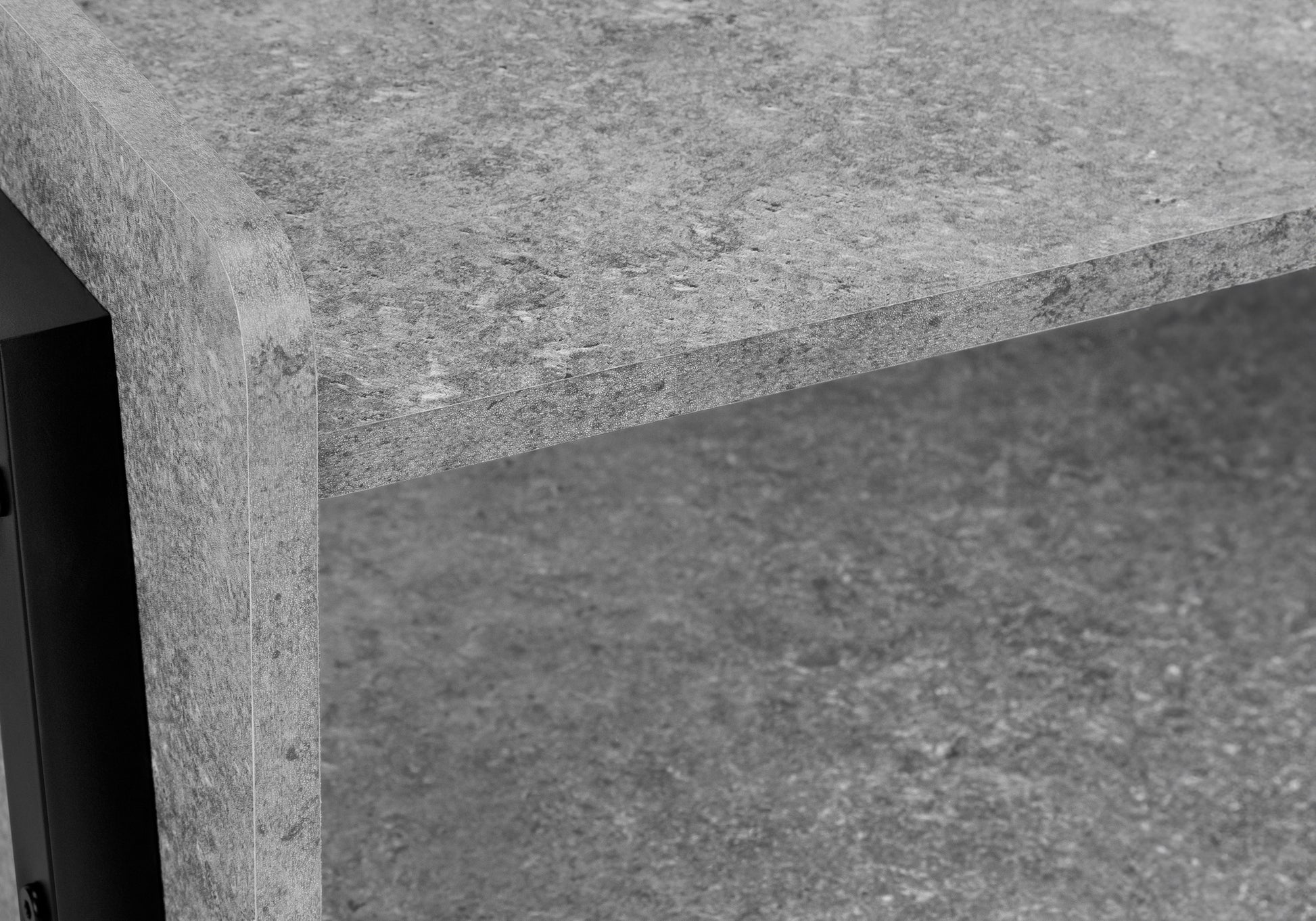 Closeup of a grey concrete effect shelf with a curved edge perfect for modern shelving