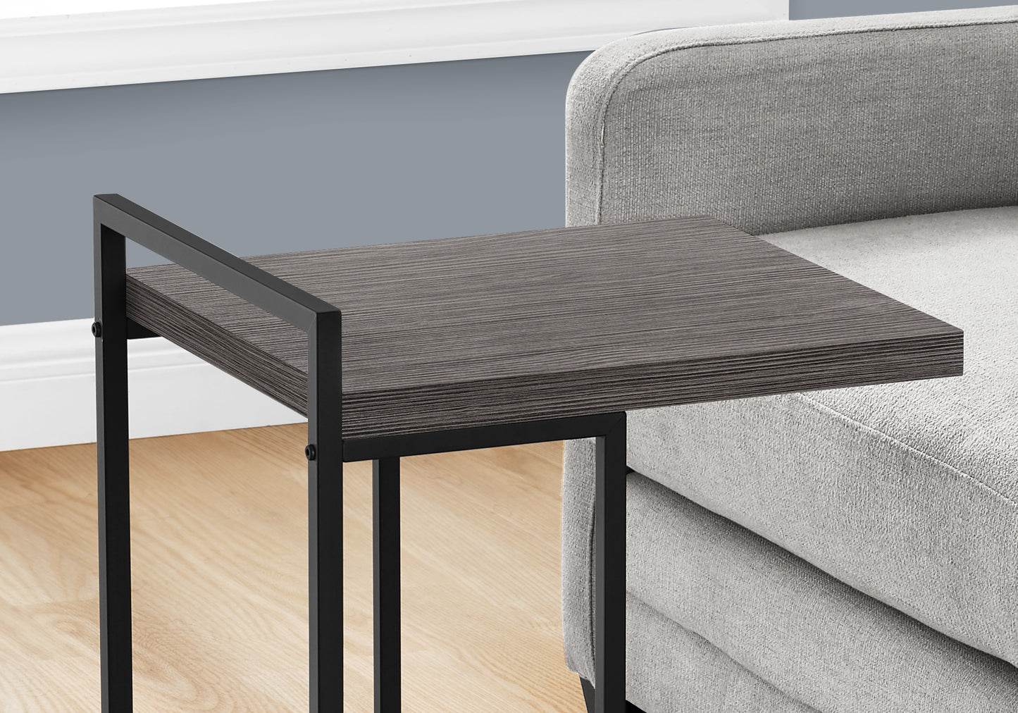 Modern Ctable with dark grey wood grain top and black metal frame ideal for small spaces