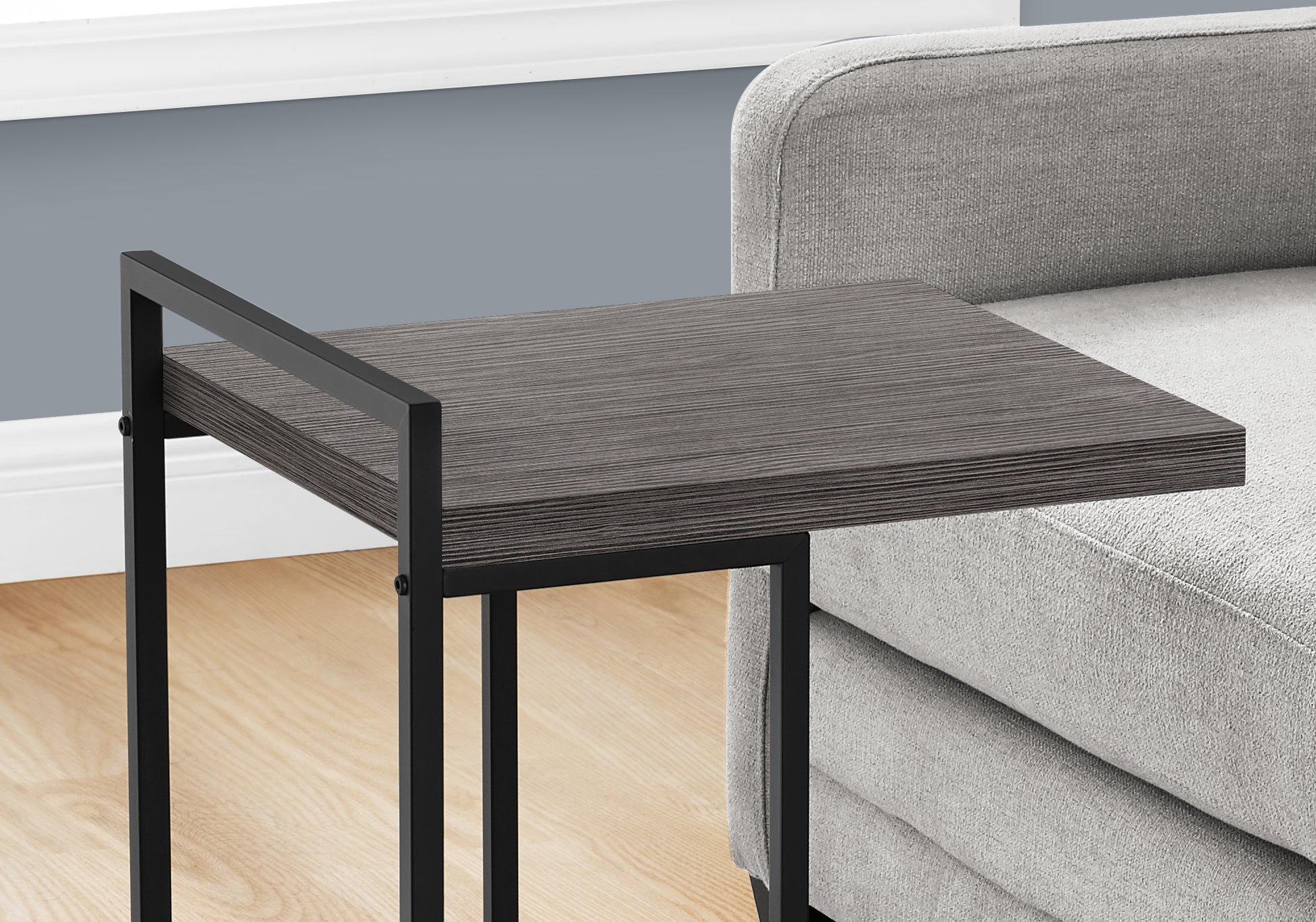 Modern Ctable with dark grey wood grain top and black metal frame ideal for small spaces