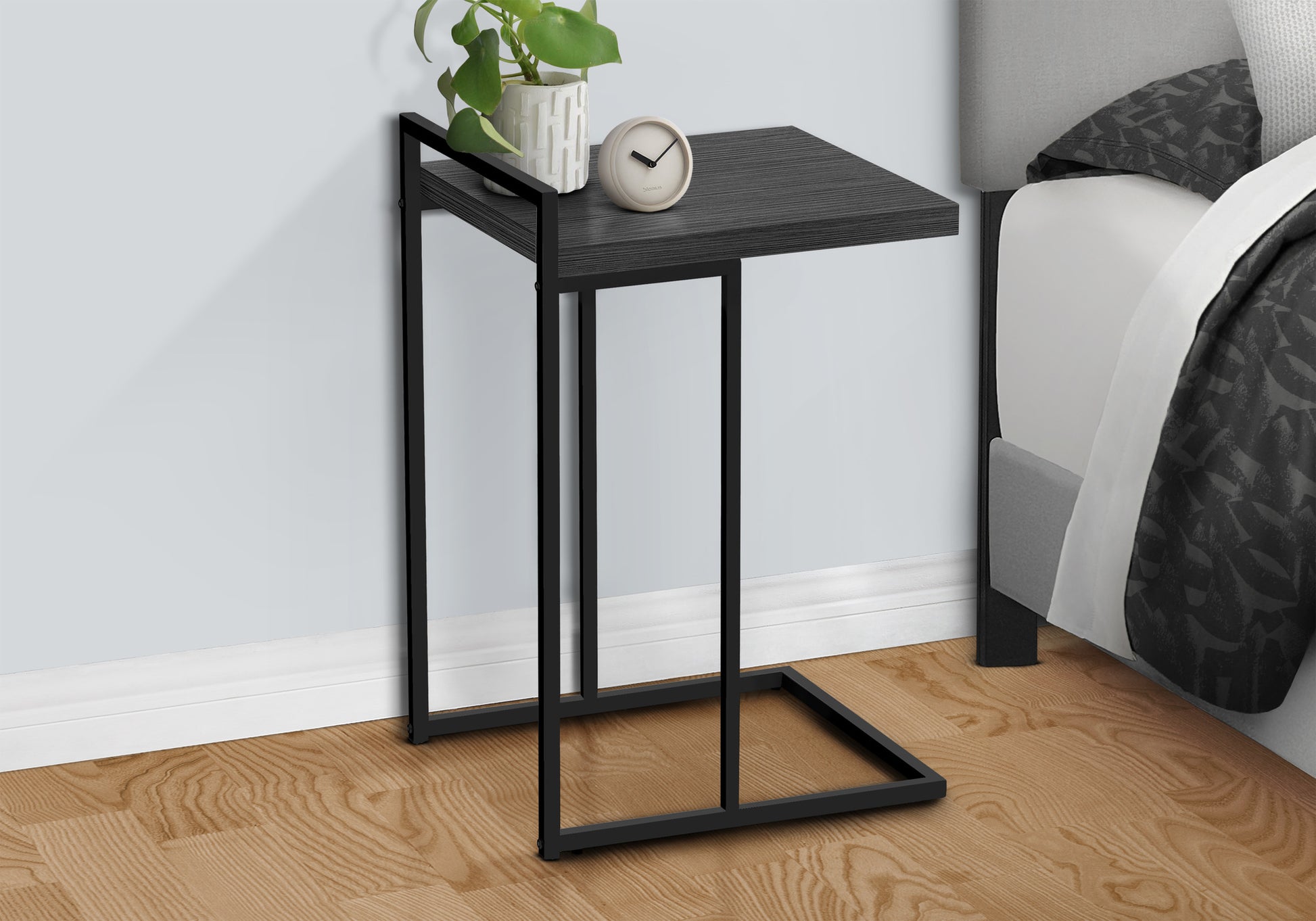 Modern Ctable with black metal frame and dark wood tabletop ideal for bedside use