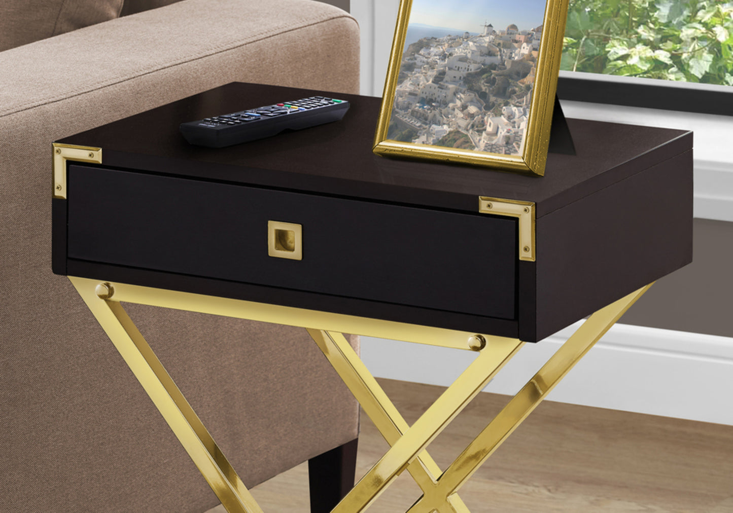 Dark wood side table with gold frame accents and drawer ideal for a modern living room