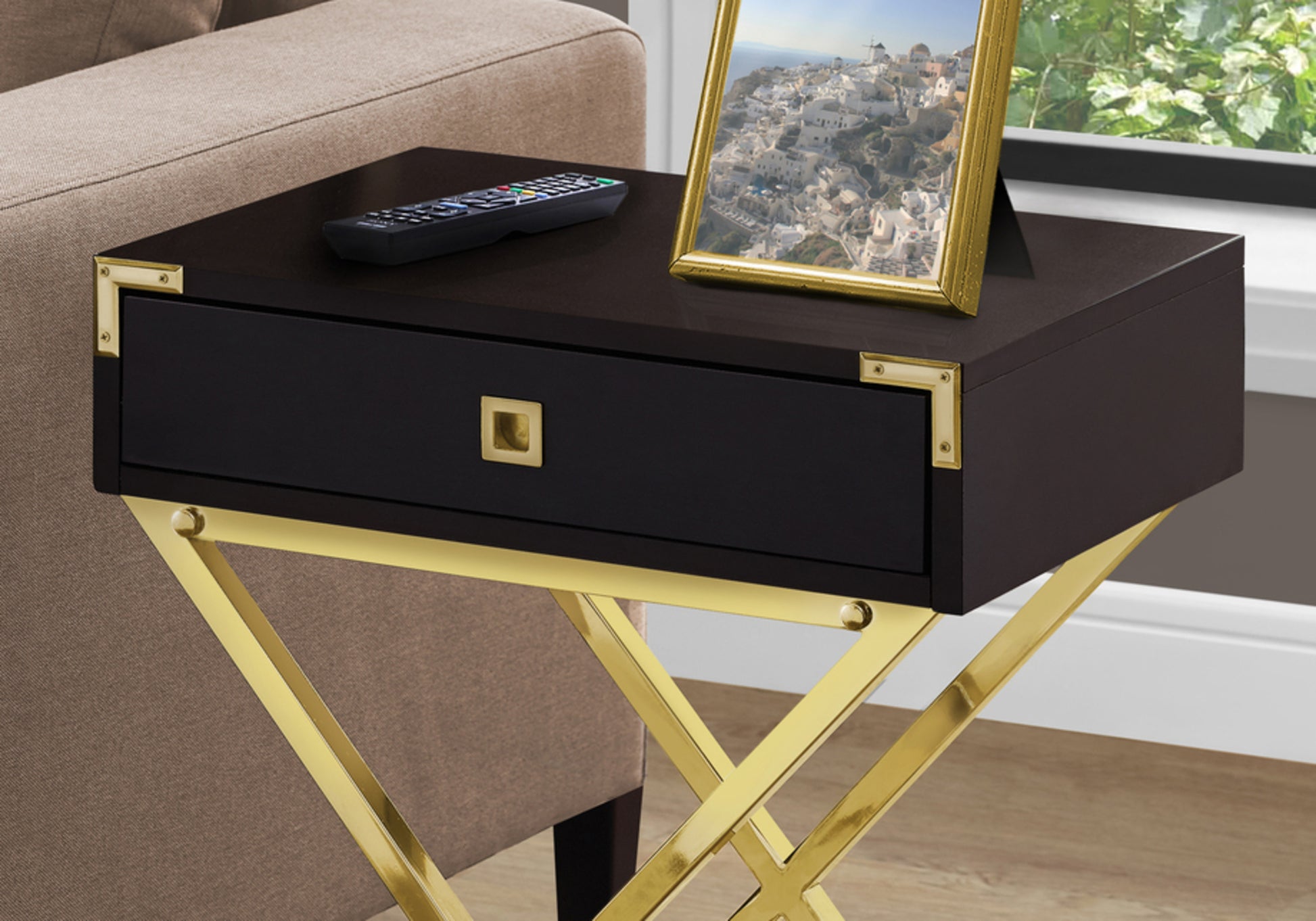 Dark wood side table with gold frame accents and drawer ideal for a modern living room