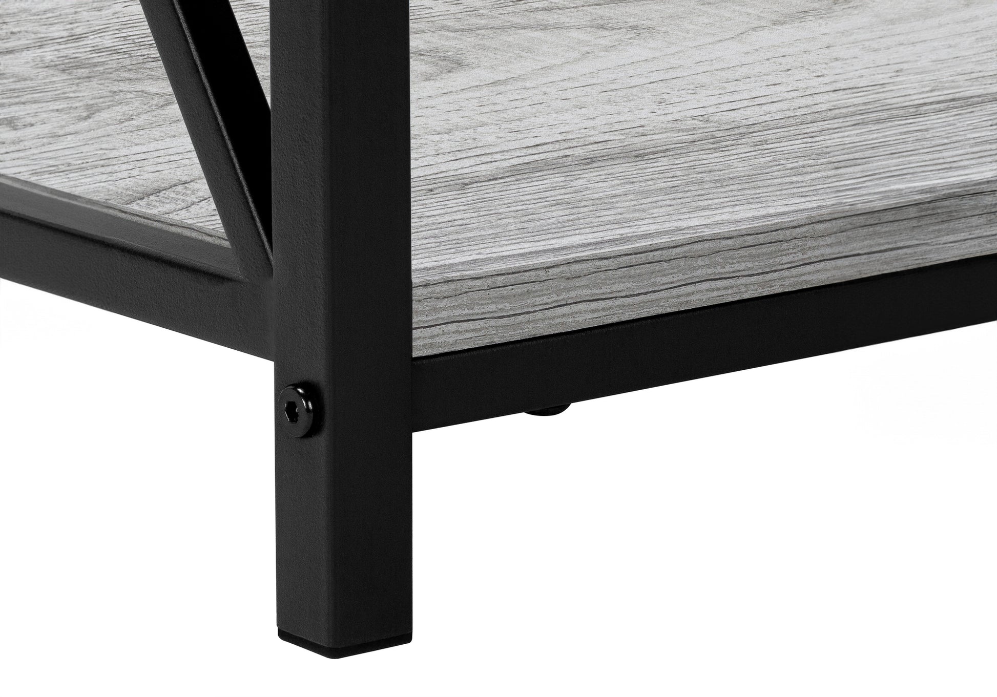 Closeup of a black metal frame corner with a gray wood grain shelf surface