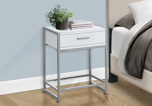 White and silver metal nightstand with one drawer and a plant