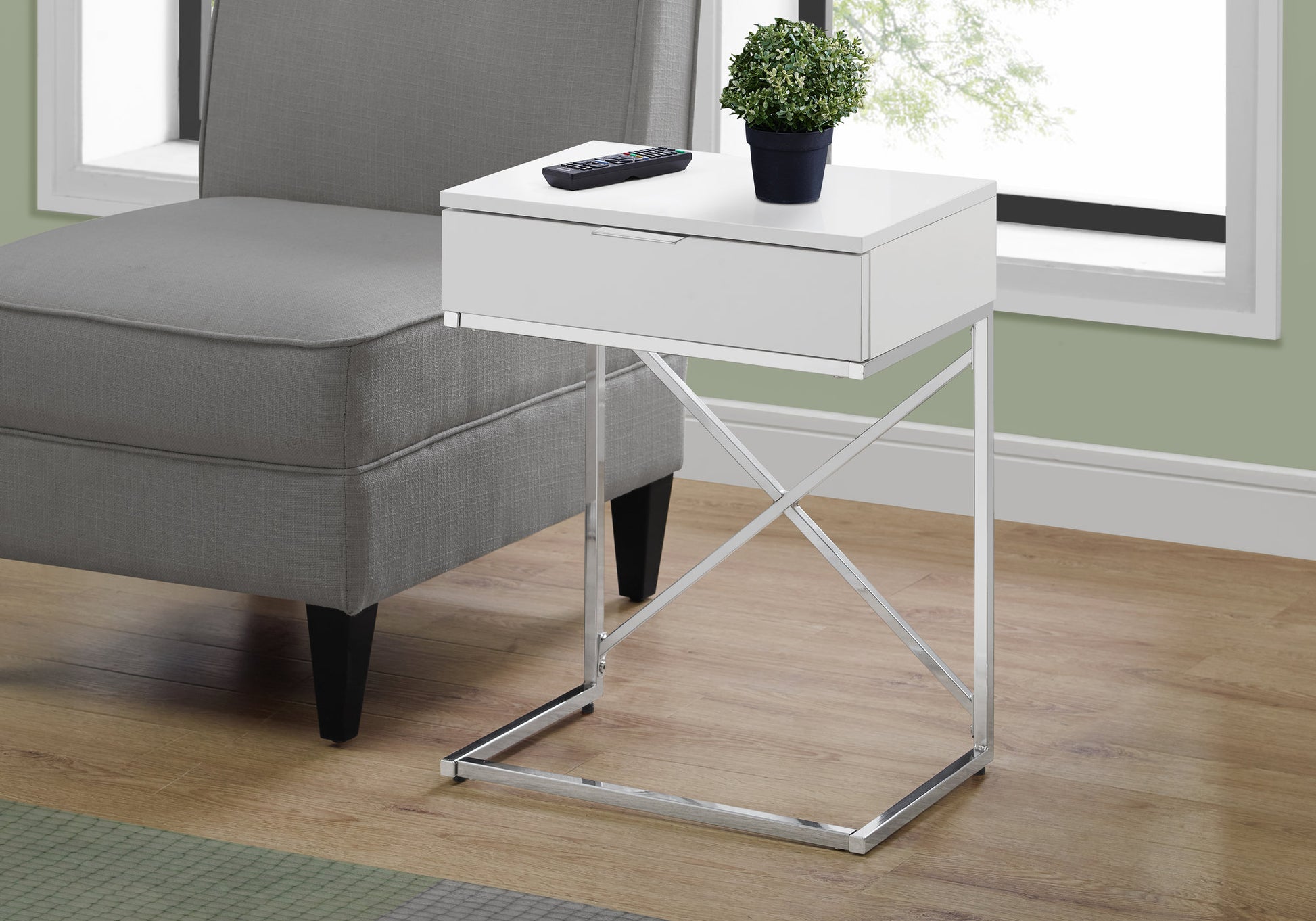 Modern white end table with chrome Xbase and a single drawer