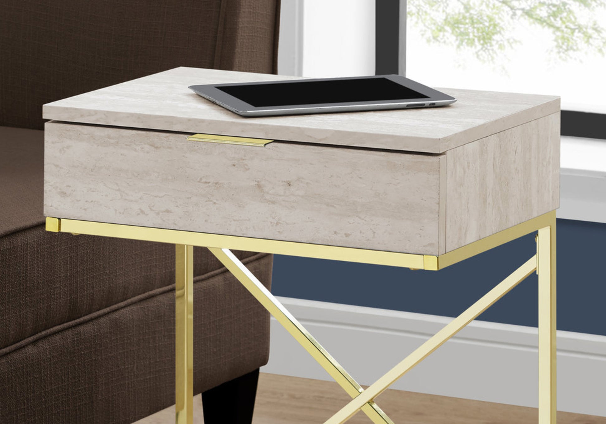 Modern beige travertine end table with a gold metal frame and drawer