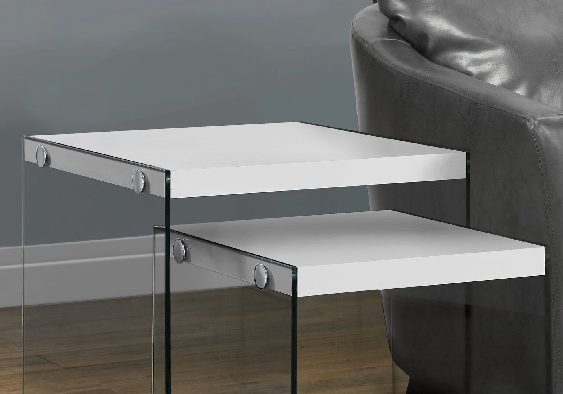 White nesting tables with clear glass sides and chrome accents
