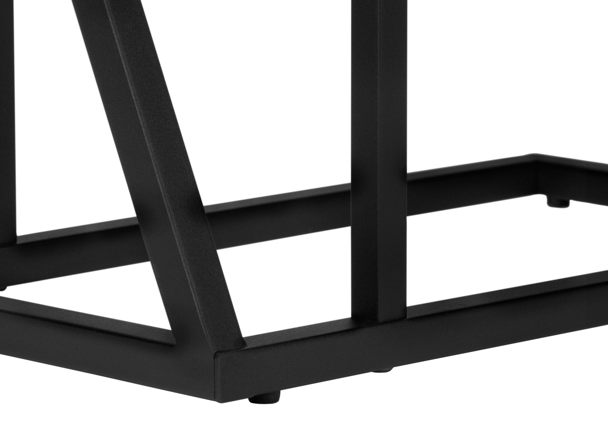 Closeup of a black metal table leg with angular supports part of a modern furniture piece