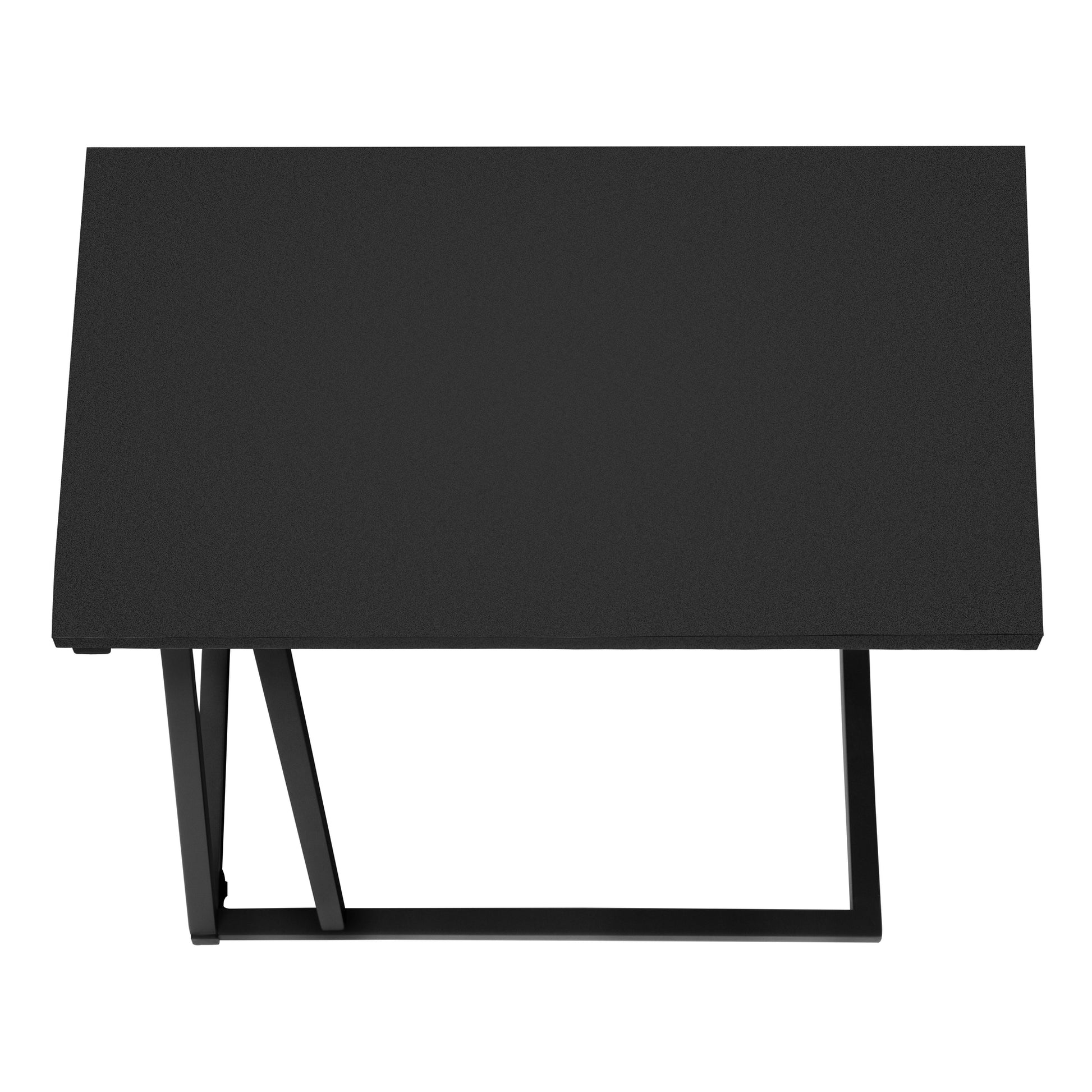 Modern black metal dining table with textured surface and angular legs for a stylish kitchen