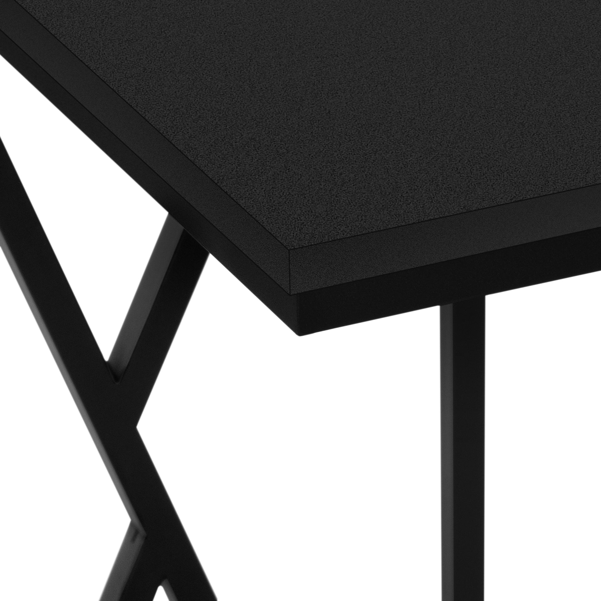 Closeup of a black textured desk surface with a modern black metal frame