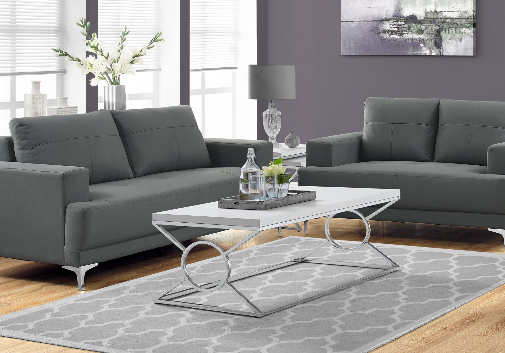 Modern charcoal grey upholstered sofa with sleek chrome legs and plush cushions