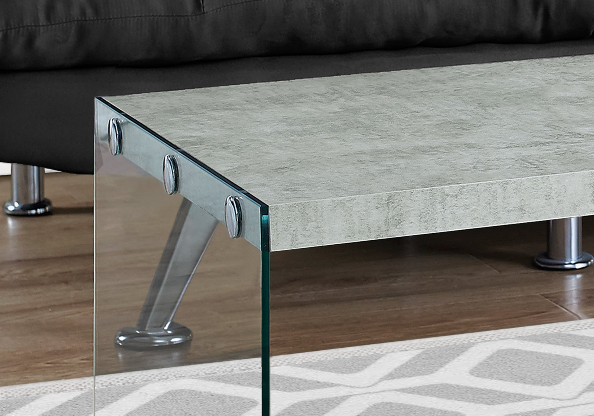 Modern grey concretelook coffee table with clear glass sides and chrome legs