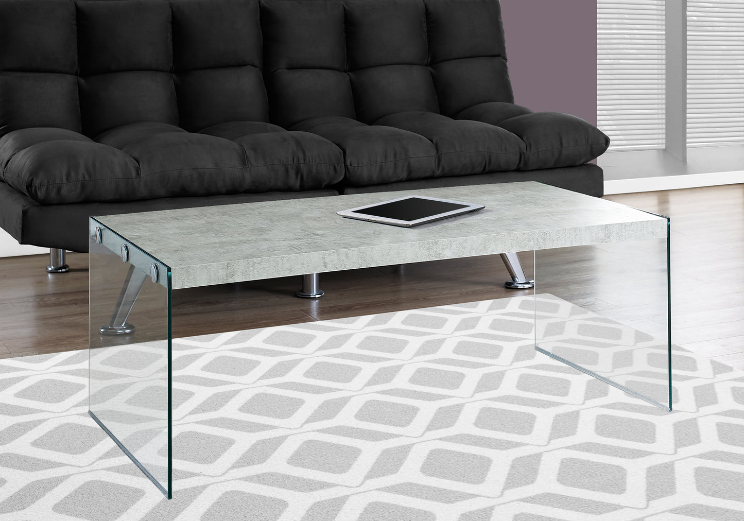 Modern grey concrete top coffee table with clear glass legs