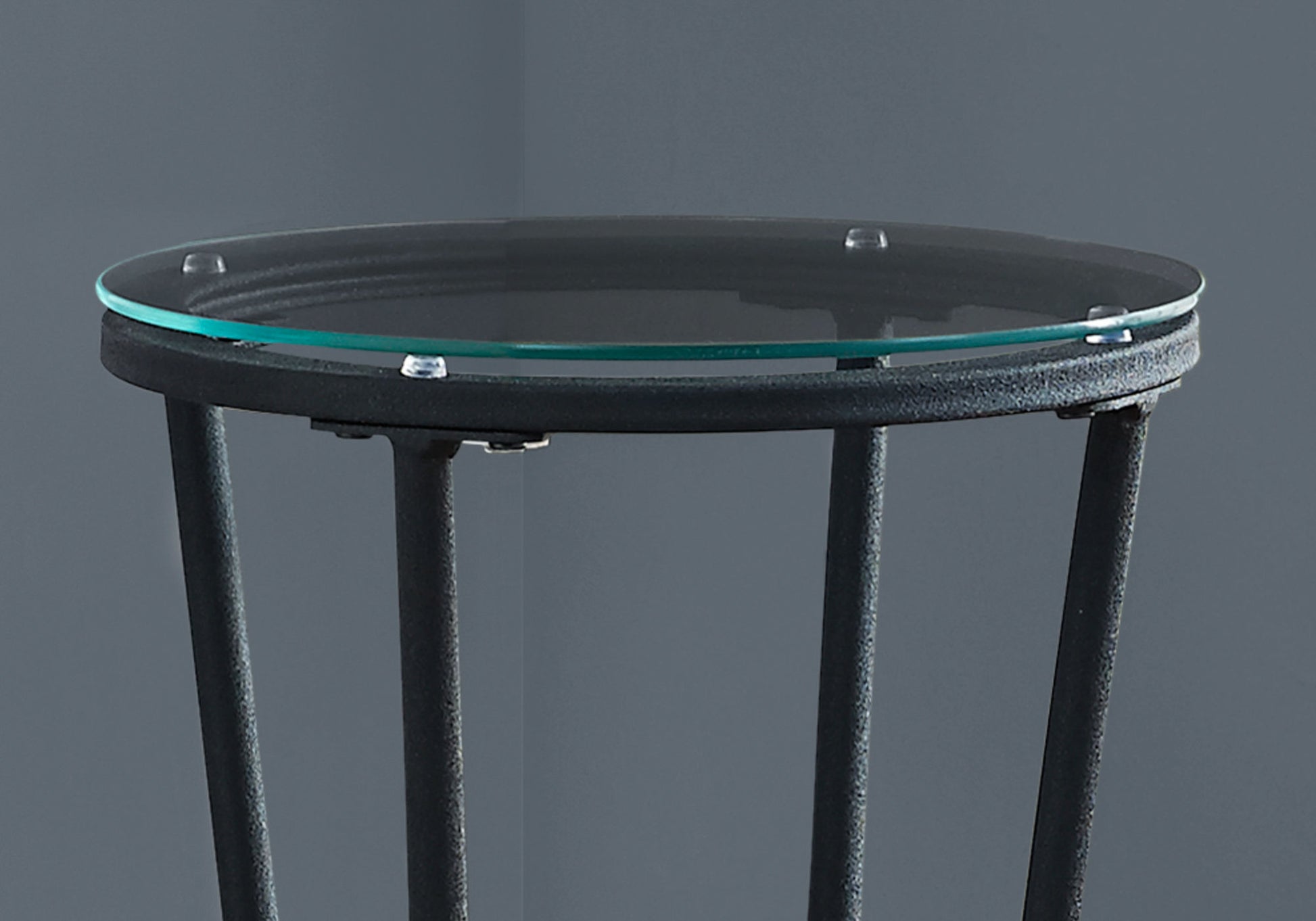 Round glass top accent table with black metal base and legs