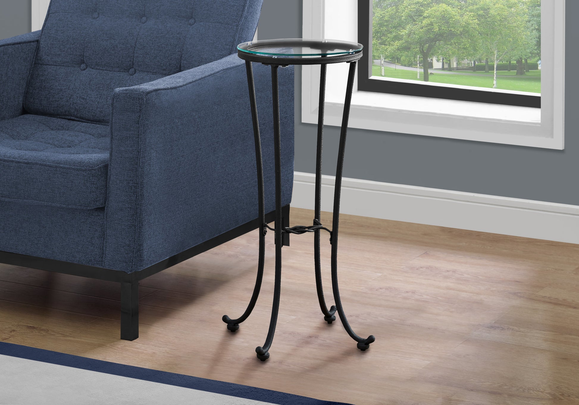 Small black metal accent table with round glass top elegant for living room decor