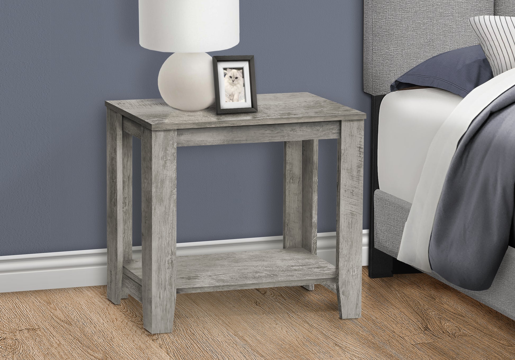 Rustic gray wood bedside table with a lower shelf and a framed photo