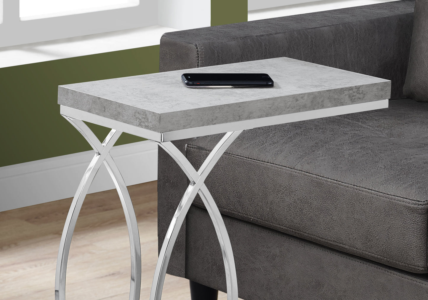 Gray concrete C table with chrome legs perfect for bedside use
