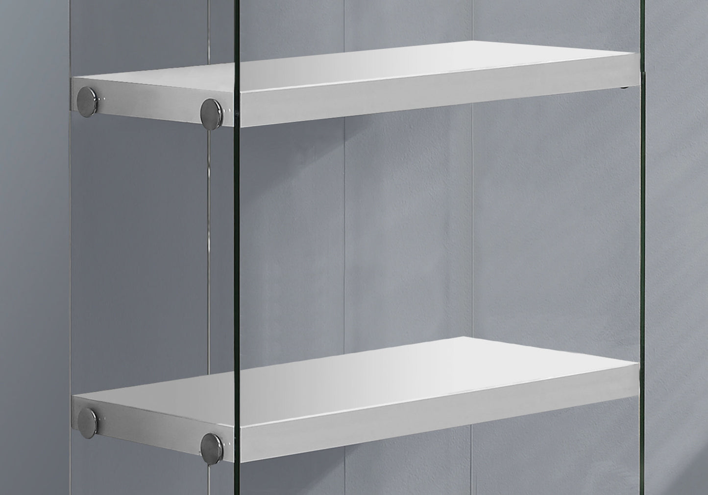 Two white floating shelves with brushed nickel supports on a grey wall