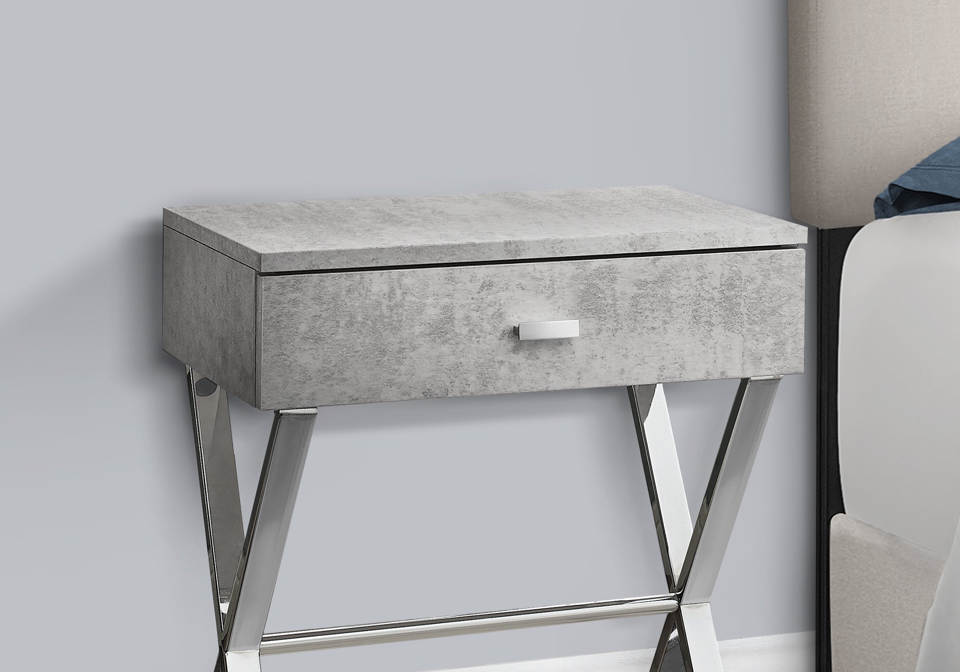 Modern gray concrete bedside table with silver legs and one drawer
