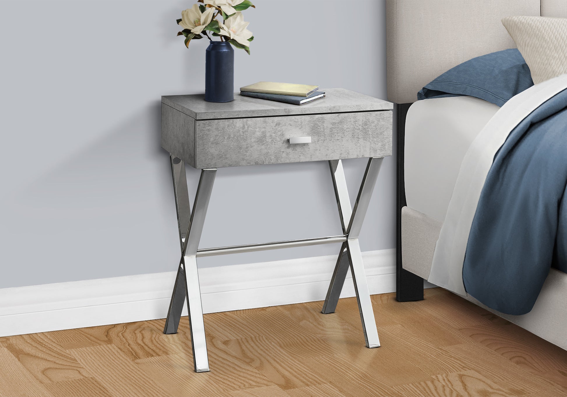 Modern grey concrete side table with chrome Xlegs and a single drawer