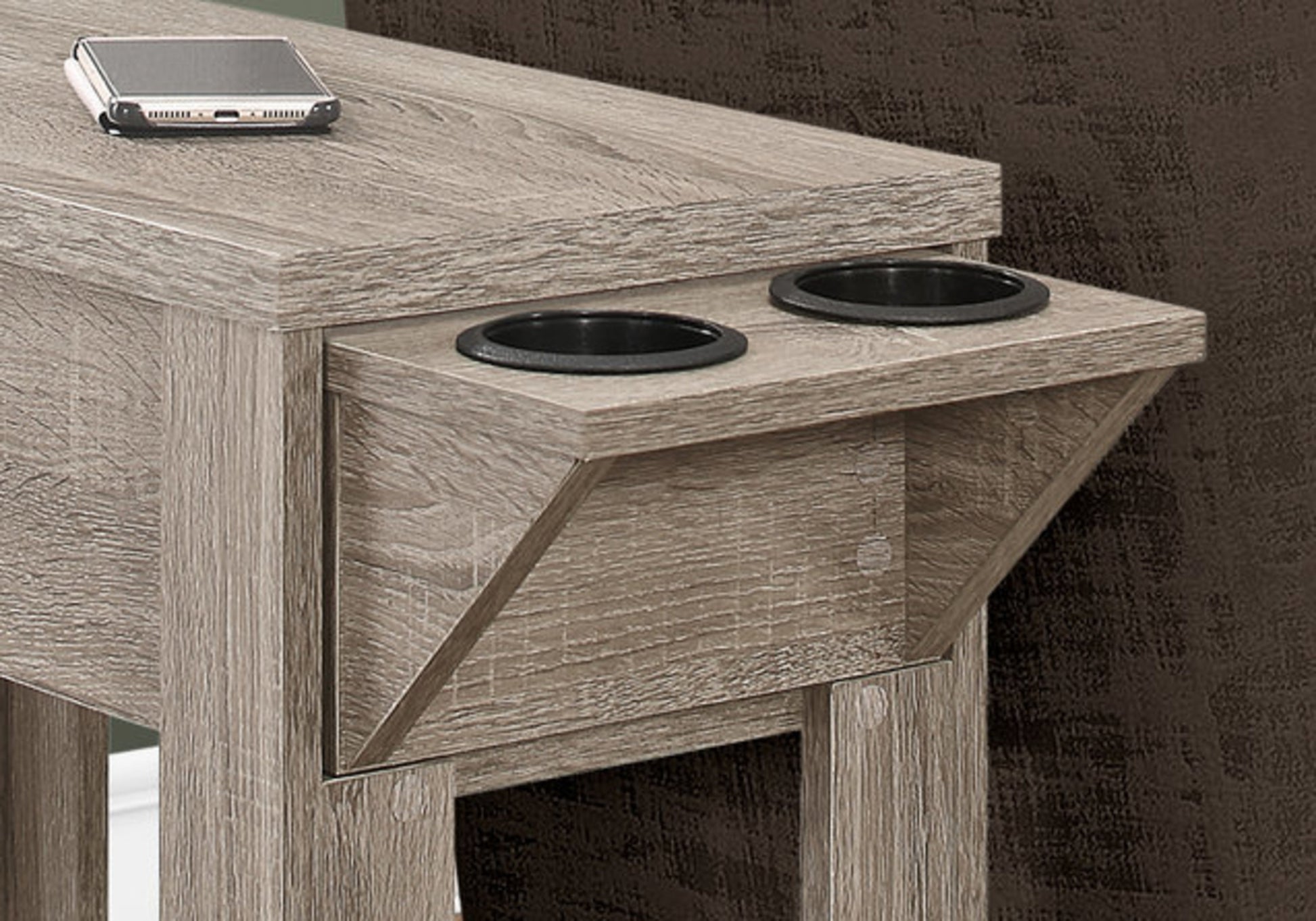 Rustic wood accent table with two black cup holders and a smartphone charging station
