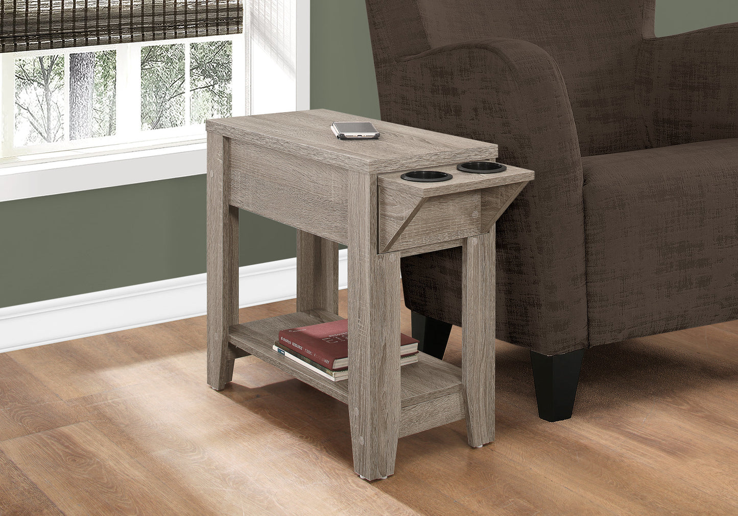 Gray washed wood narrow end table with two cup holders and storage drawer next to armchair