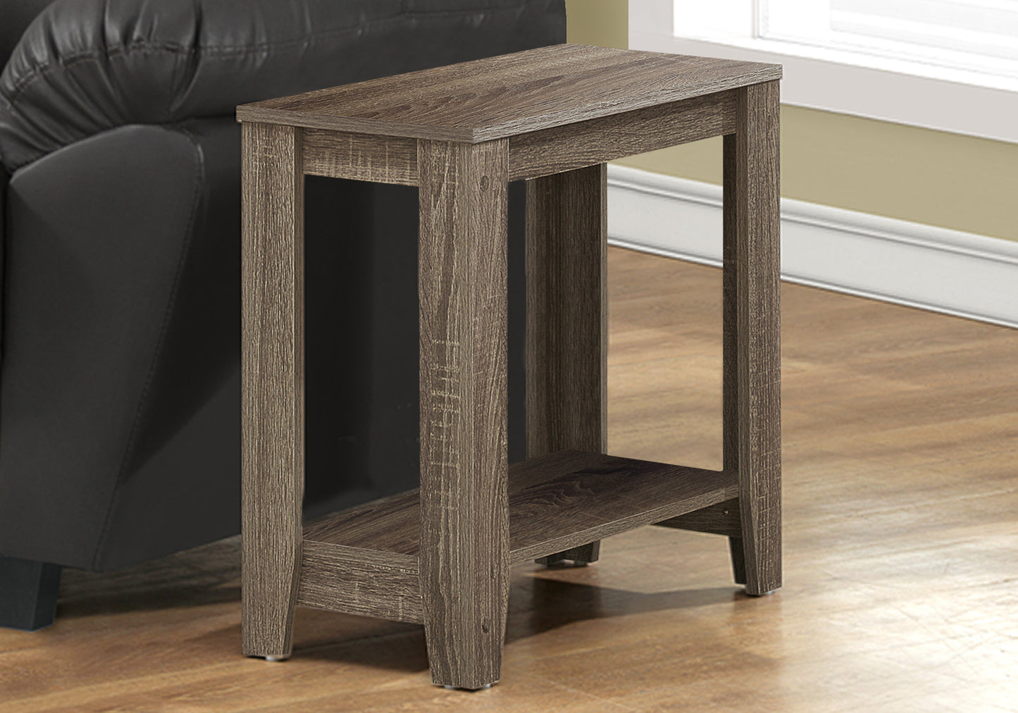 Rustic brown accent table with two shelves beside a black leather sofa