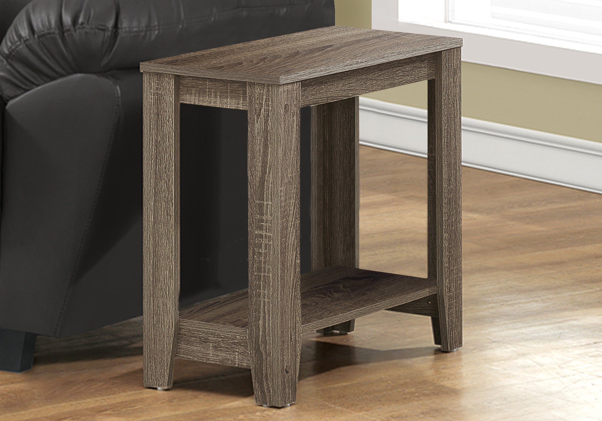 Rustic brown accent table with two shelves beside a black leather sofa