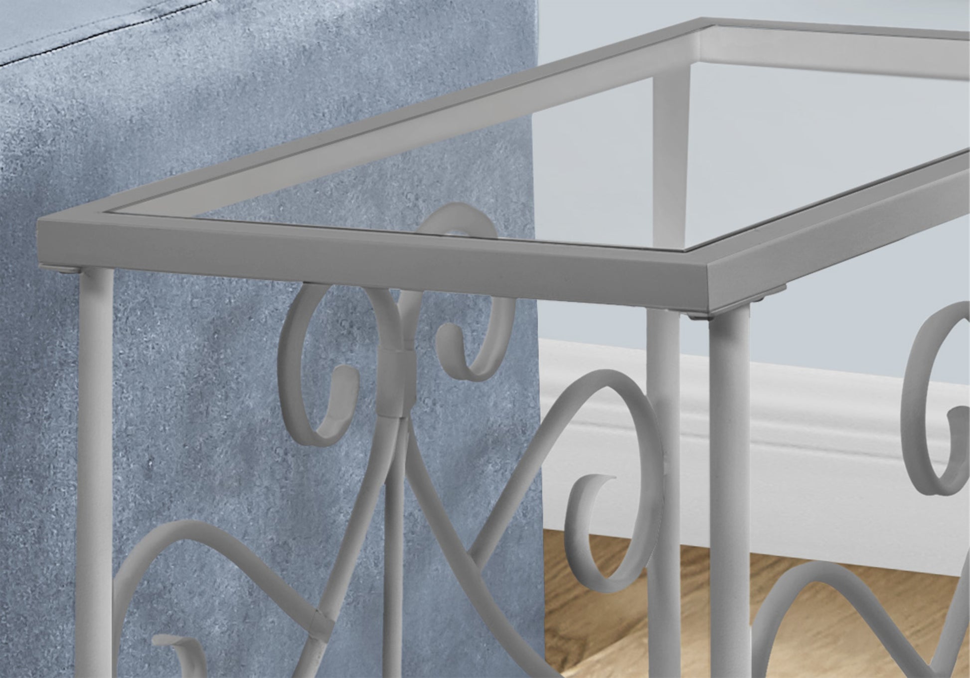 Grey metal and glass console table with ornate scrolled legs perfect for entryways