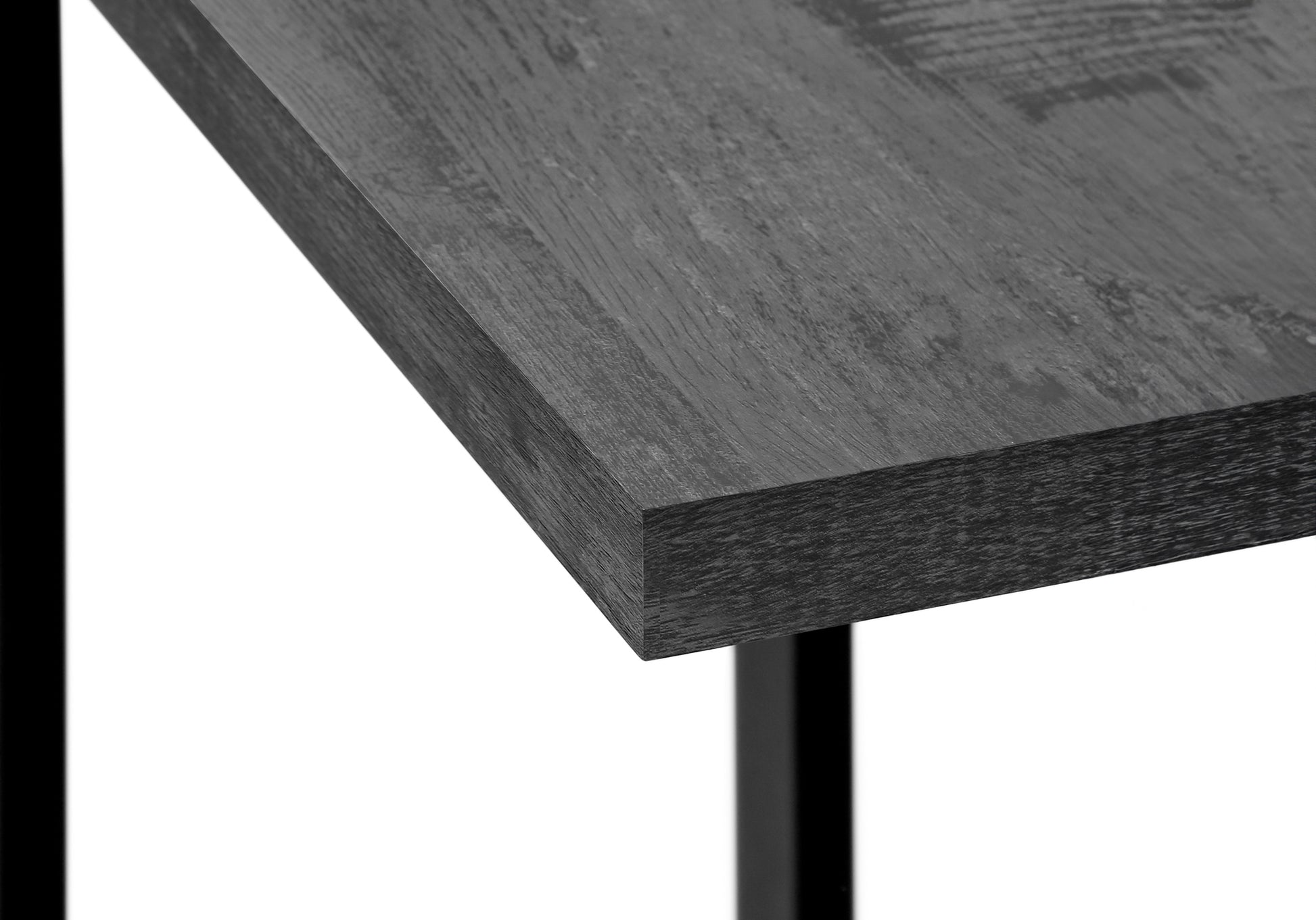 Dark grey wood grain desktop detail with black metal leg support