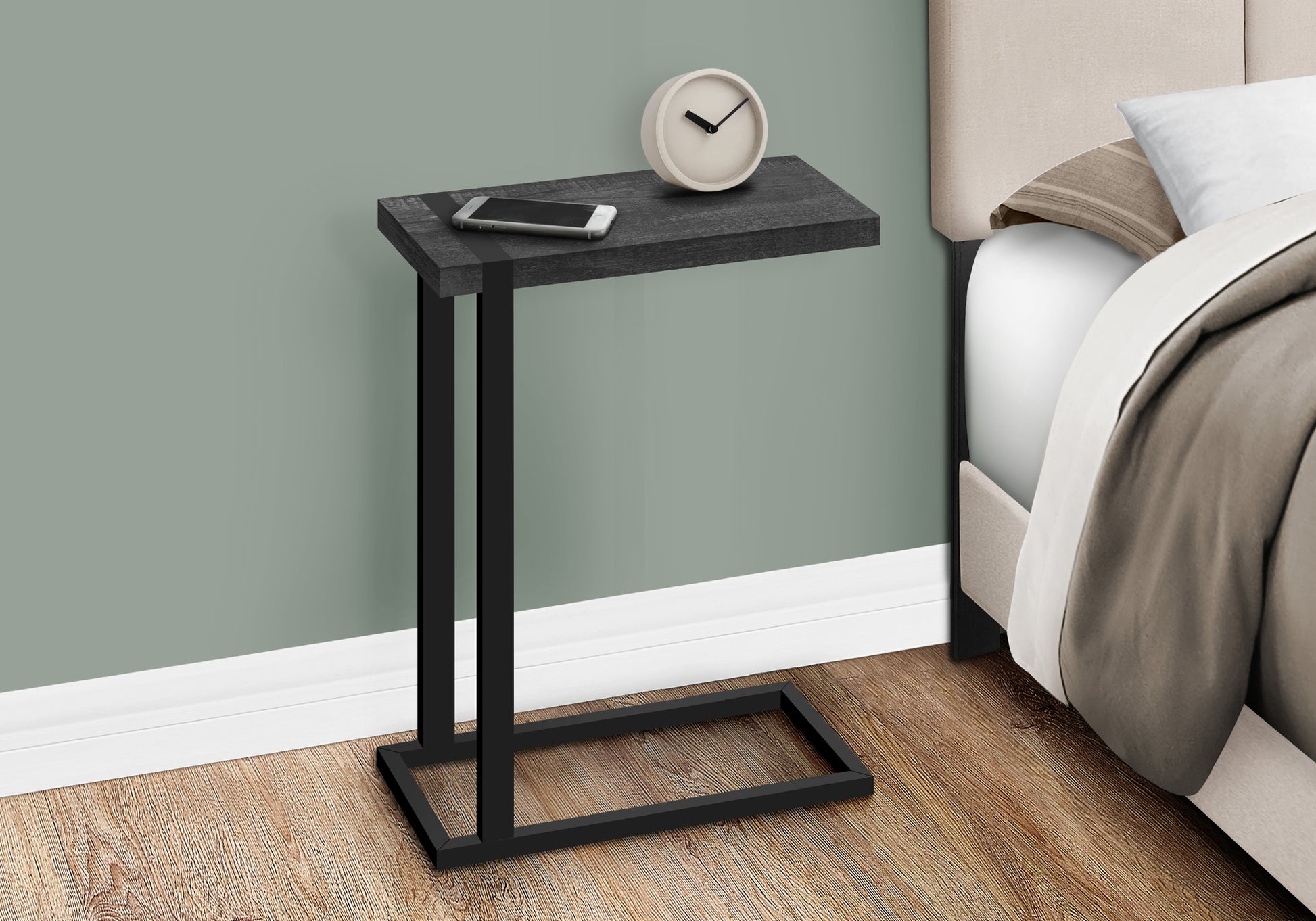 Dark gray wood Ctable with black metal frame holding a phone and clock