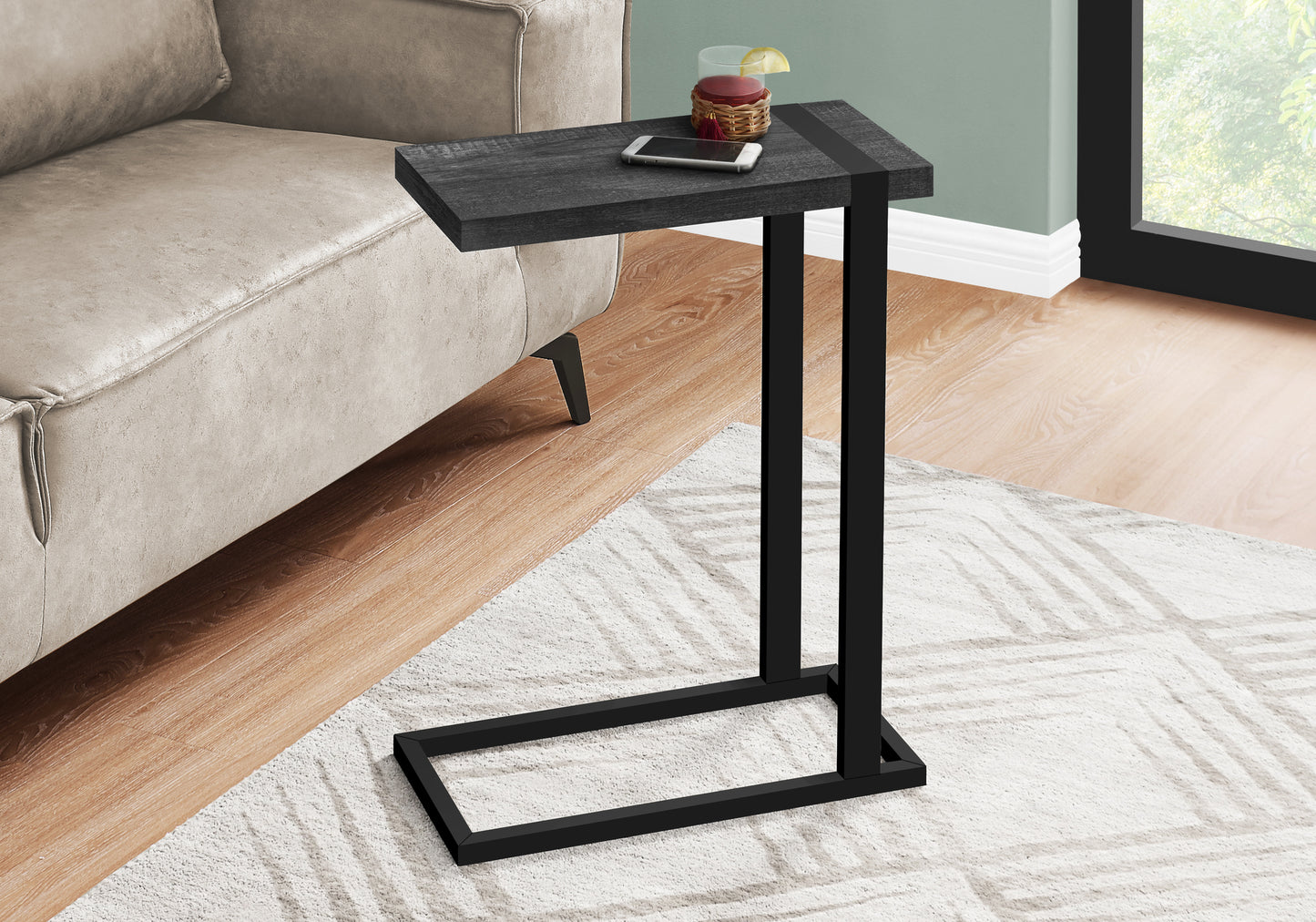 Charcoal wood top Ctable with black metal frame beside sofa