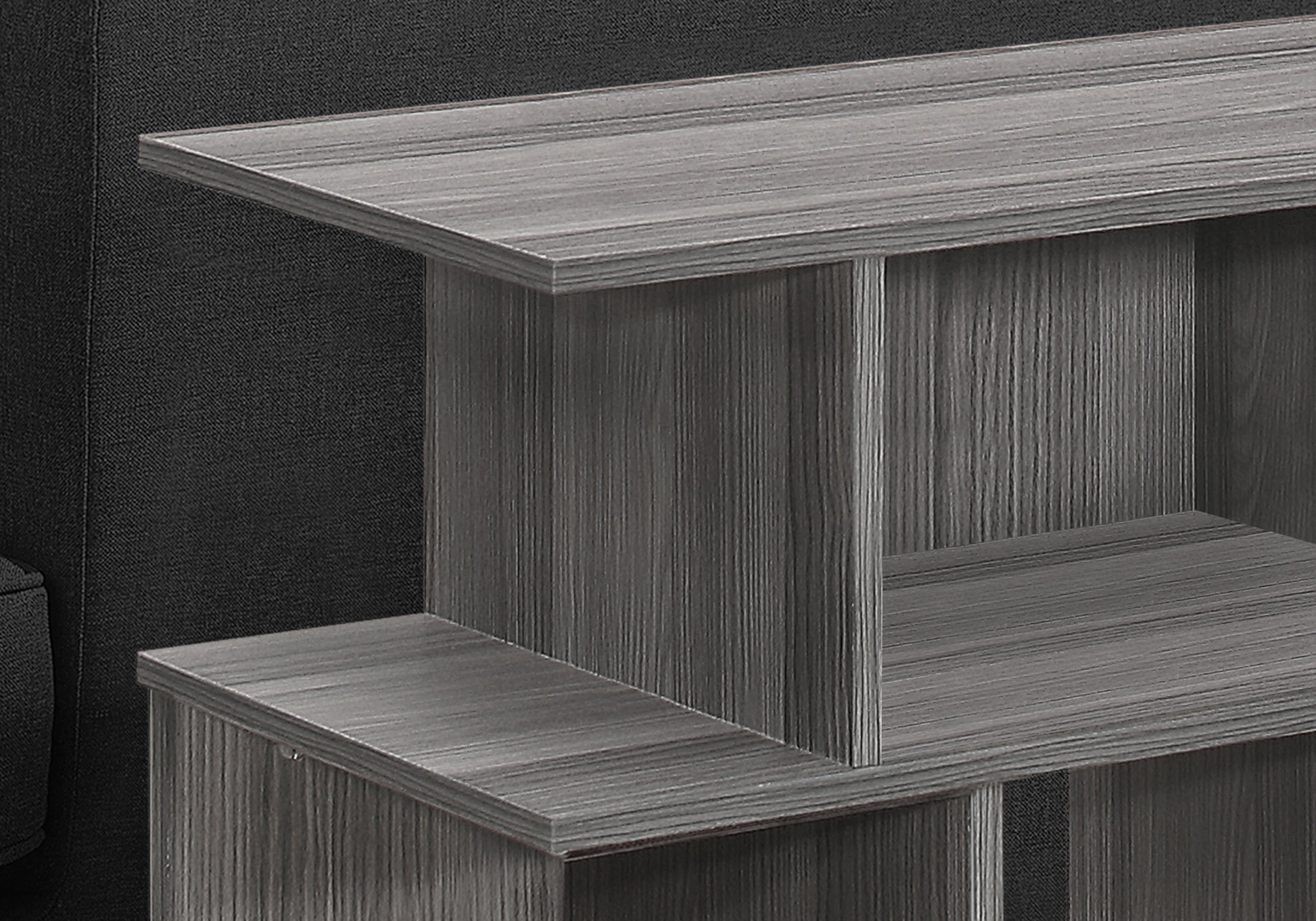 Gray wood grain end table with open shelving  characters