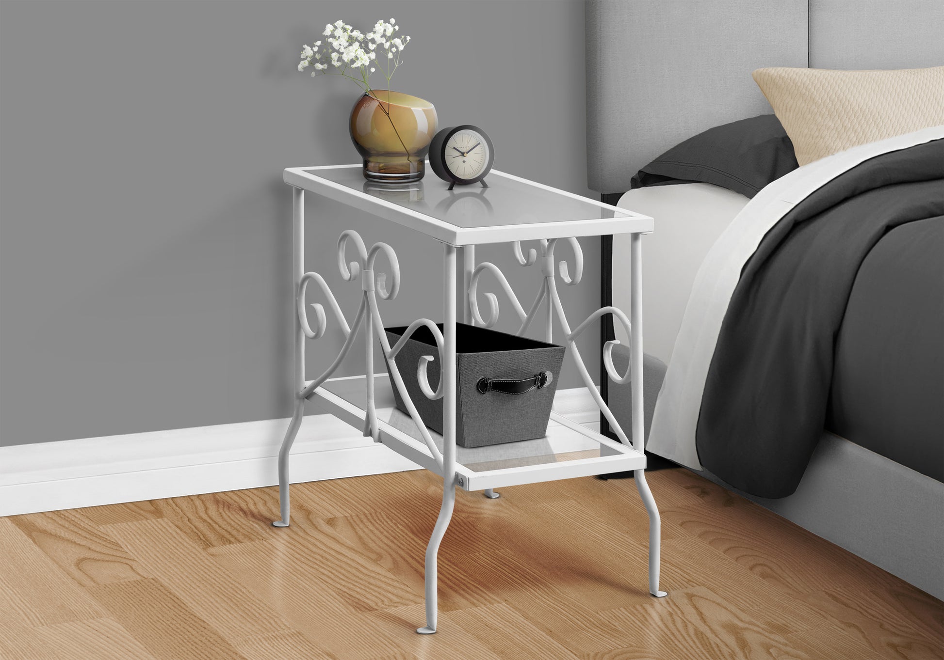 White metal accent table with glass top and decorative scrollwork