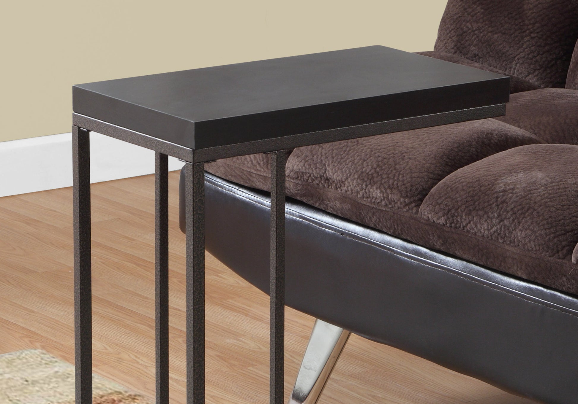 Modern cshaped table with a dark wood top and metal base perfect for couchside use