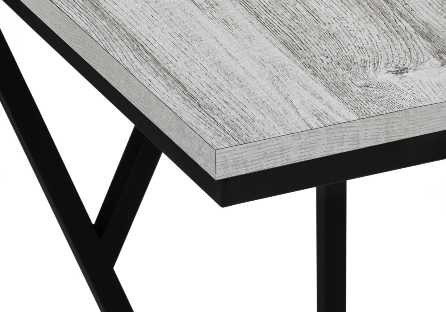 Closeup of a rustic gray wood desk with black metal legs