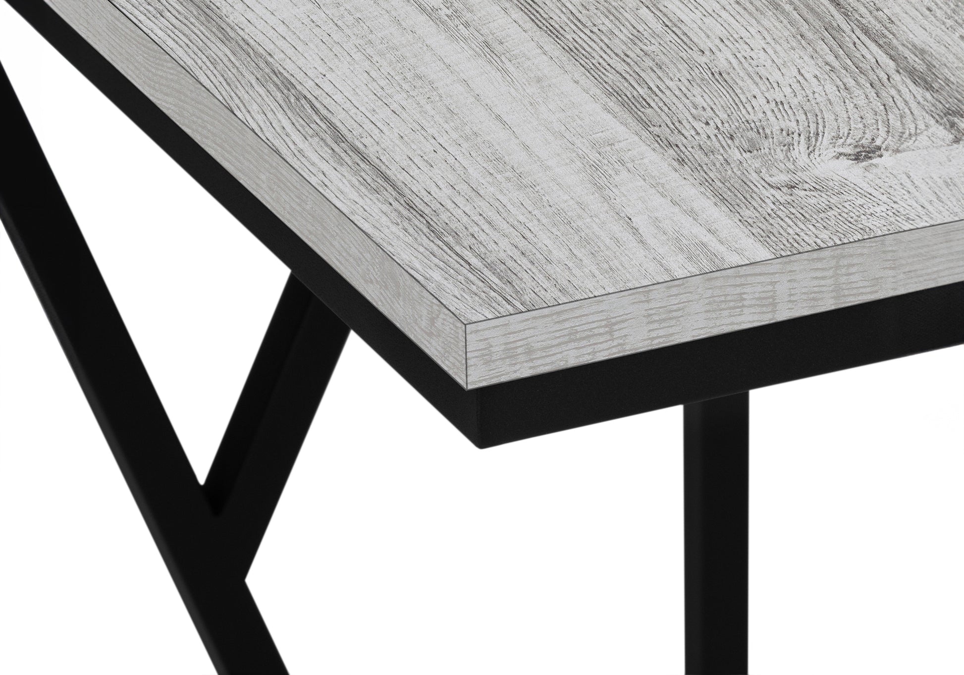 Closeup of a rustic gray wood desk with black metal legs