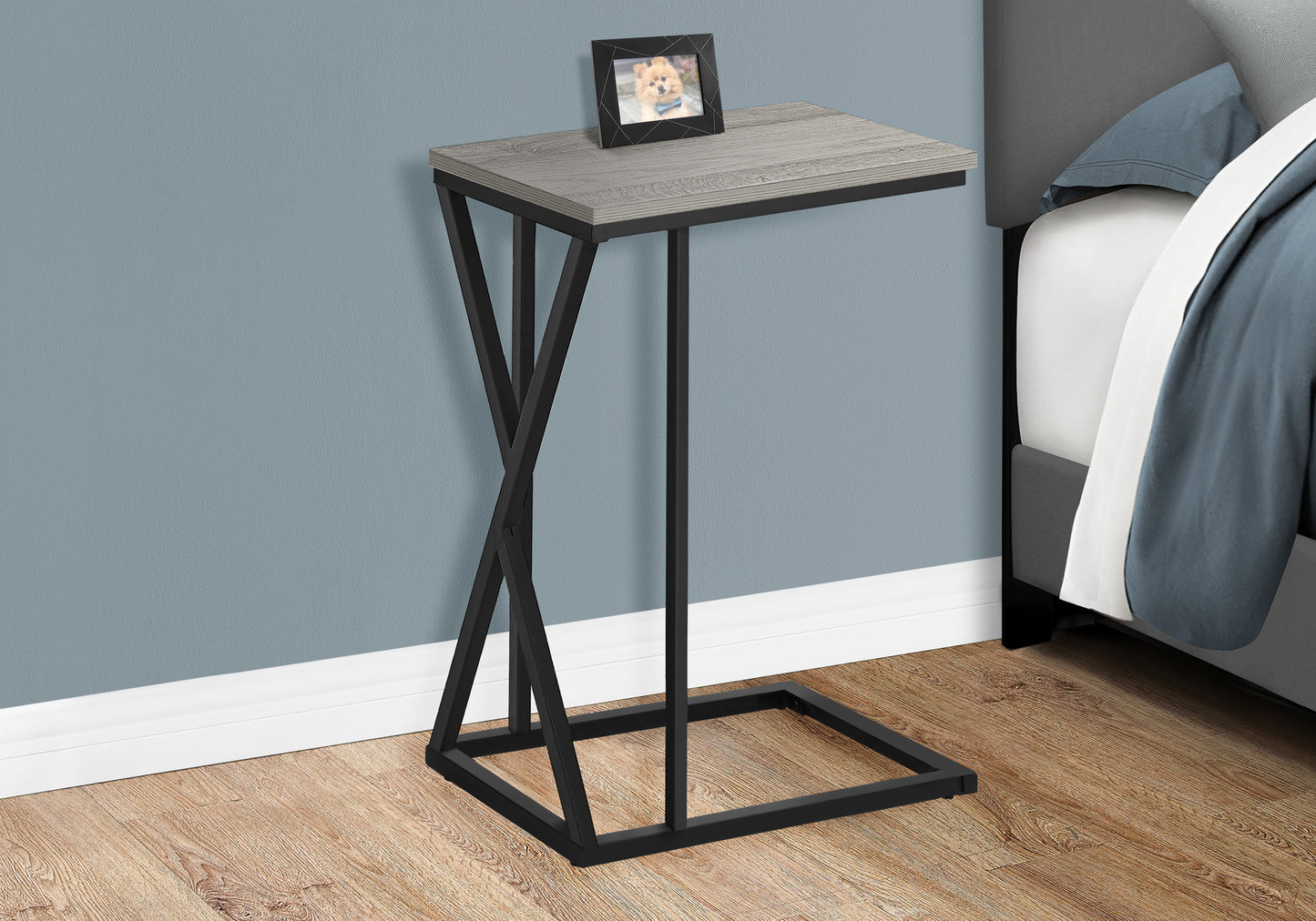 Gray wood grain ctable with black metal frame and picture frame