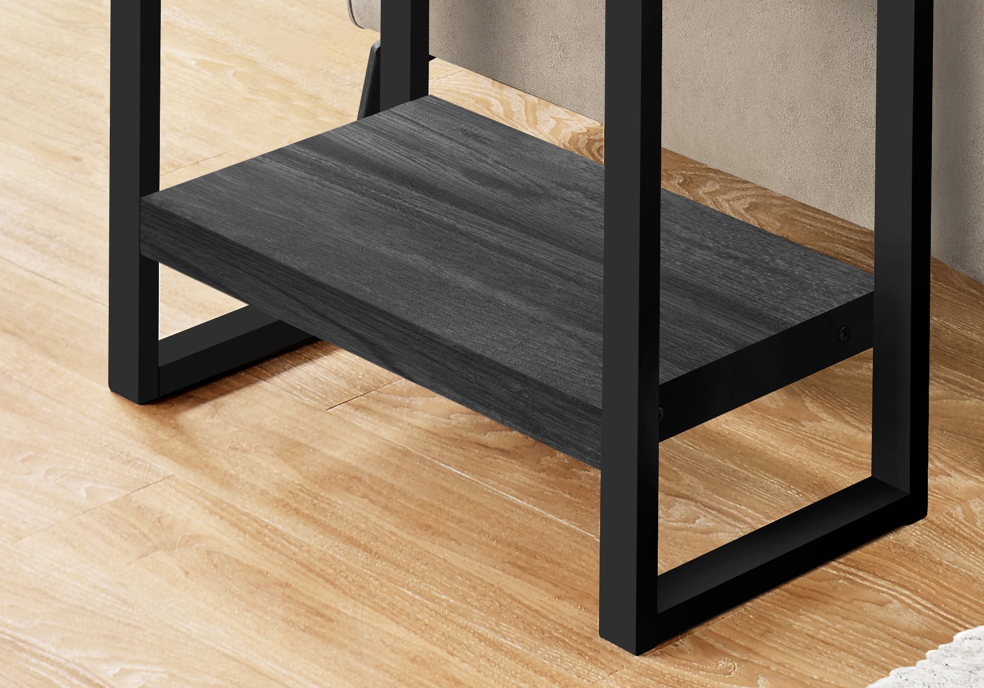 Closeup of a dark gray wood grain shelf with a black metal frame