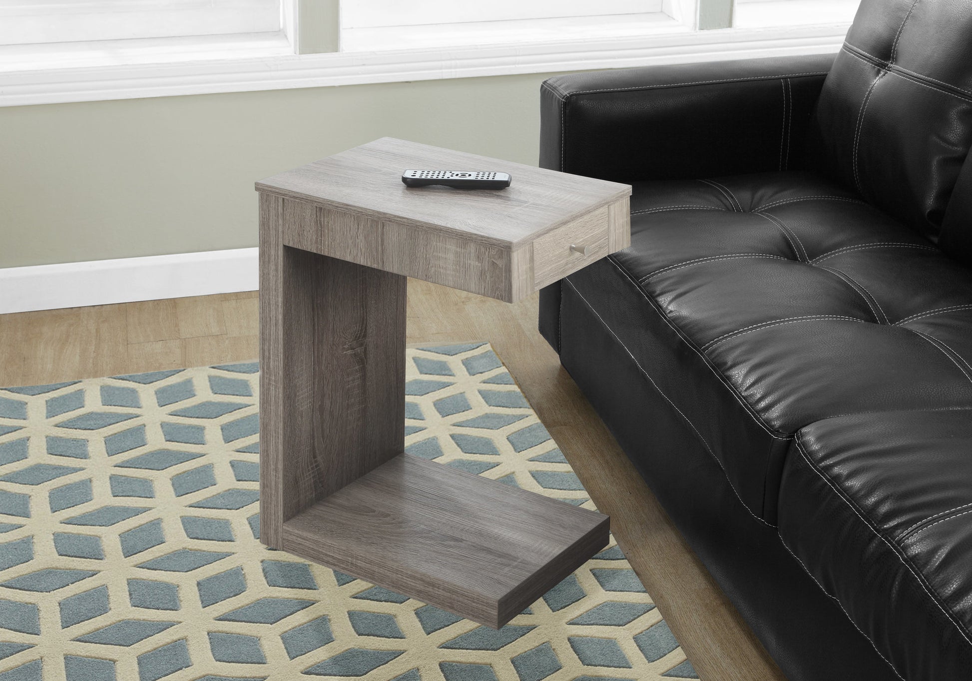 Grey wood ctable with drawer next to black leather sofa for living room