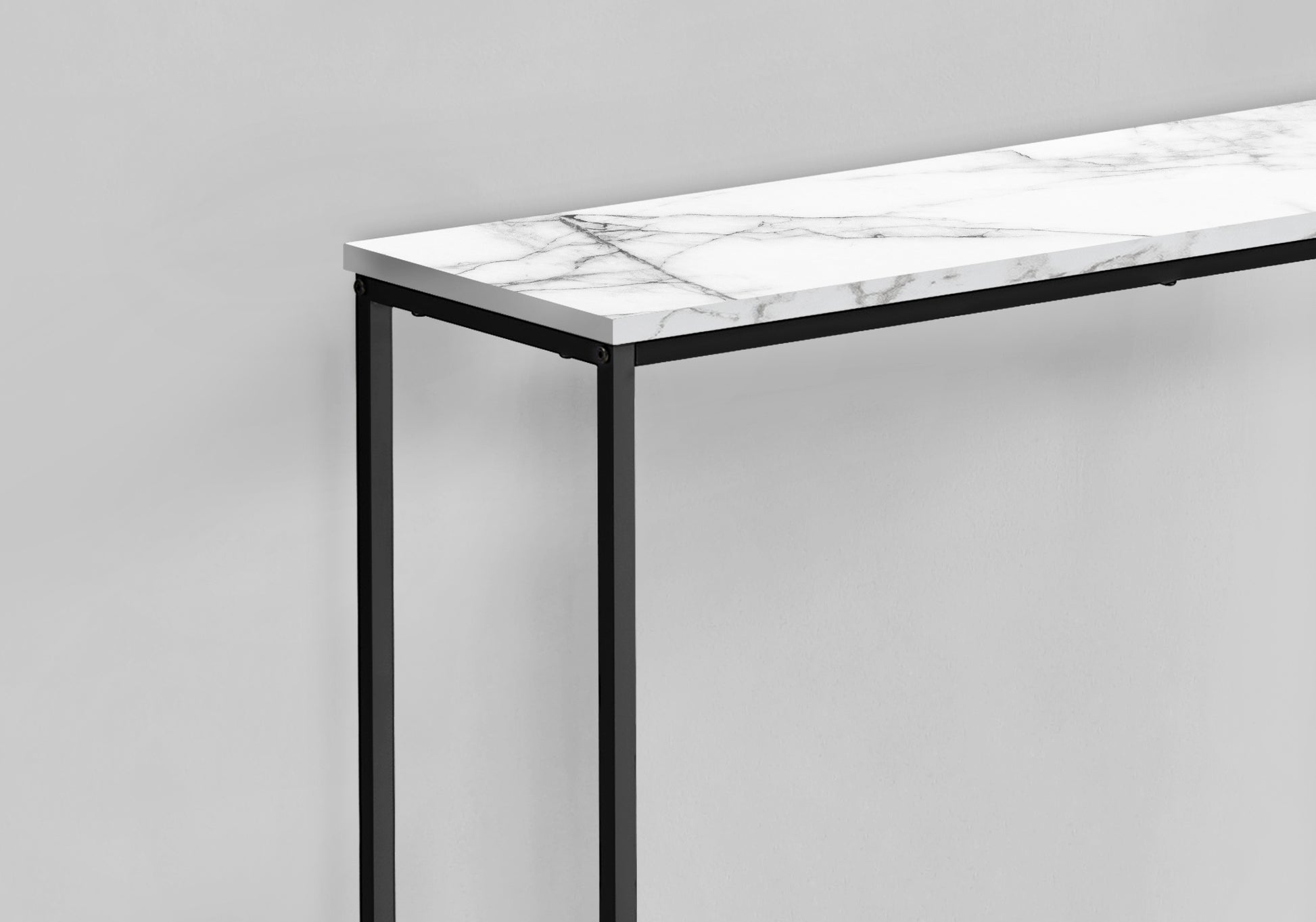 White marble console table with slender black metal legs