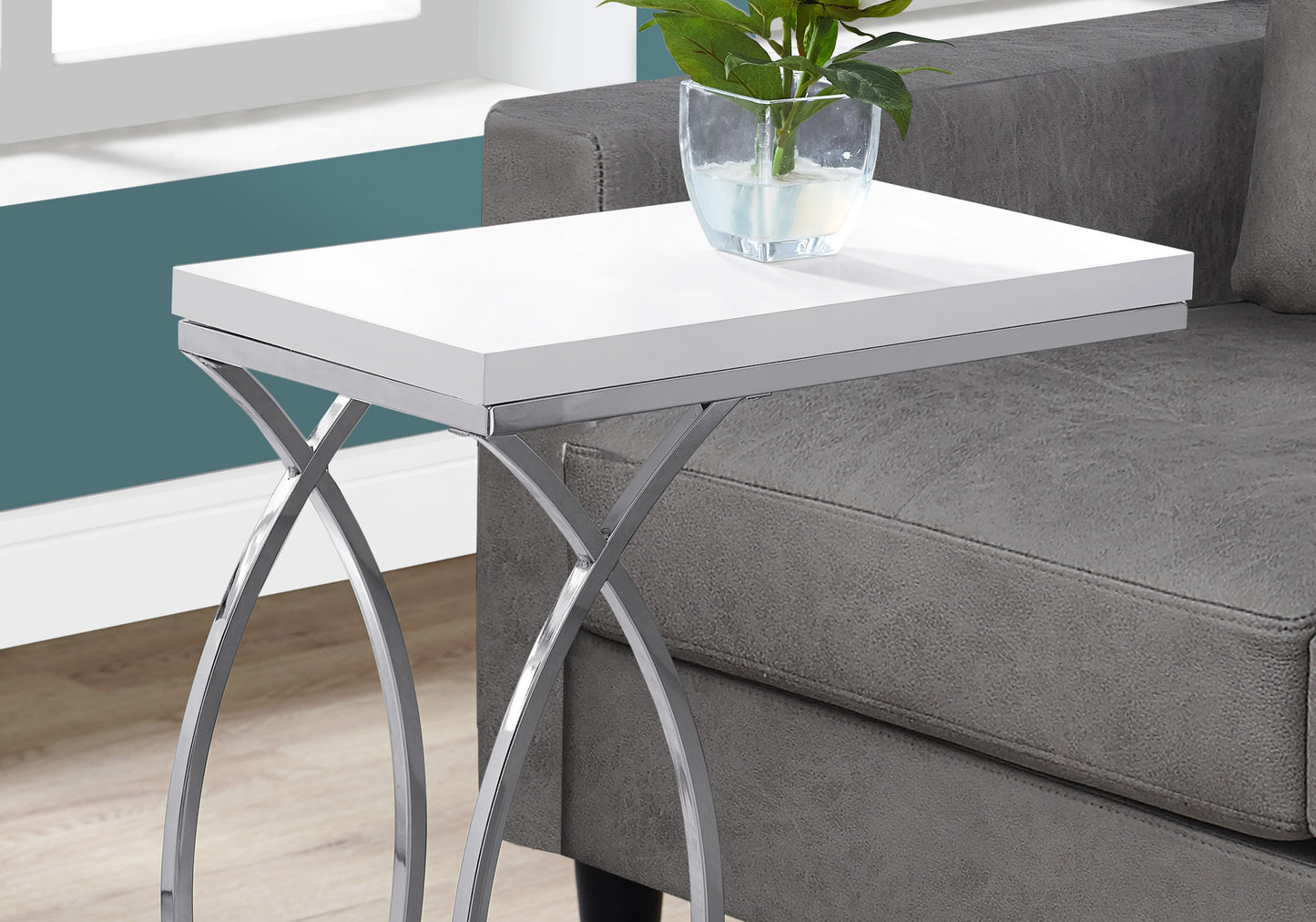 White ctable with chrome hairpin legs next to sofa