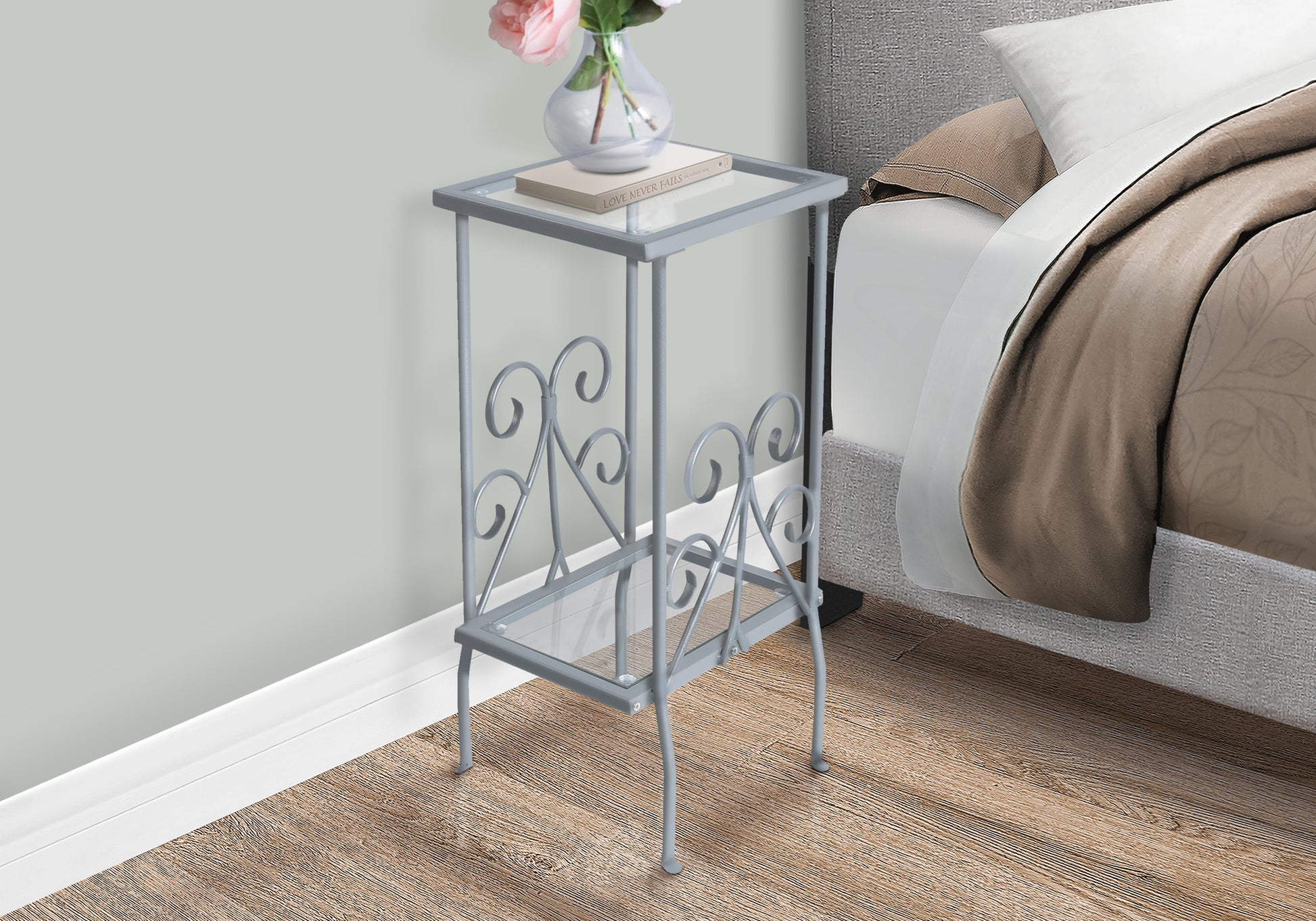 Gray metal end table with glass top and scroll details perfect for bedroom decor