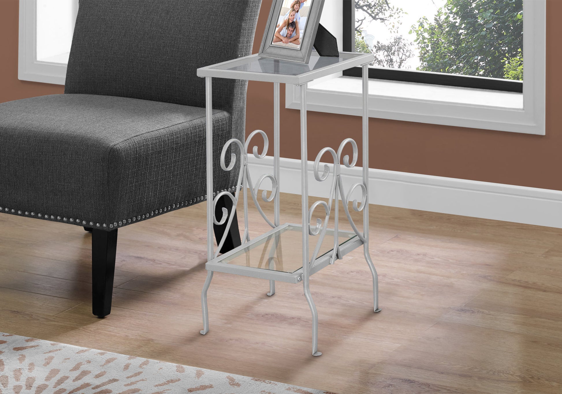 White metal accent table with ornate scrolls and glass shelves ideal for small spaces