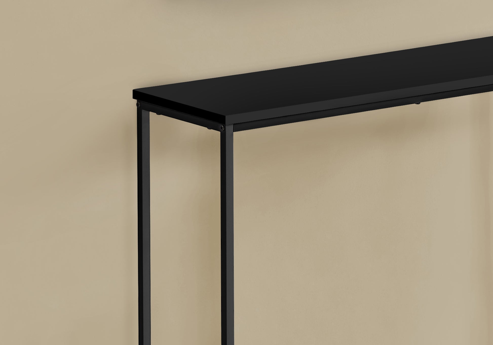 Sleek black console table with thin metal legs perfect for entryways