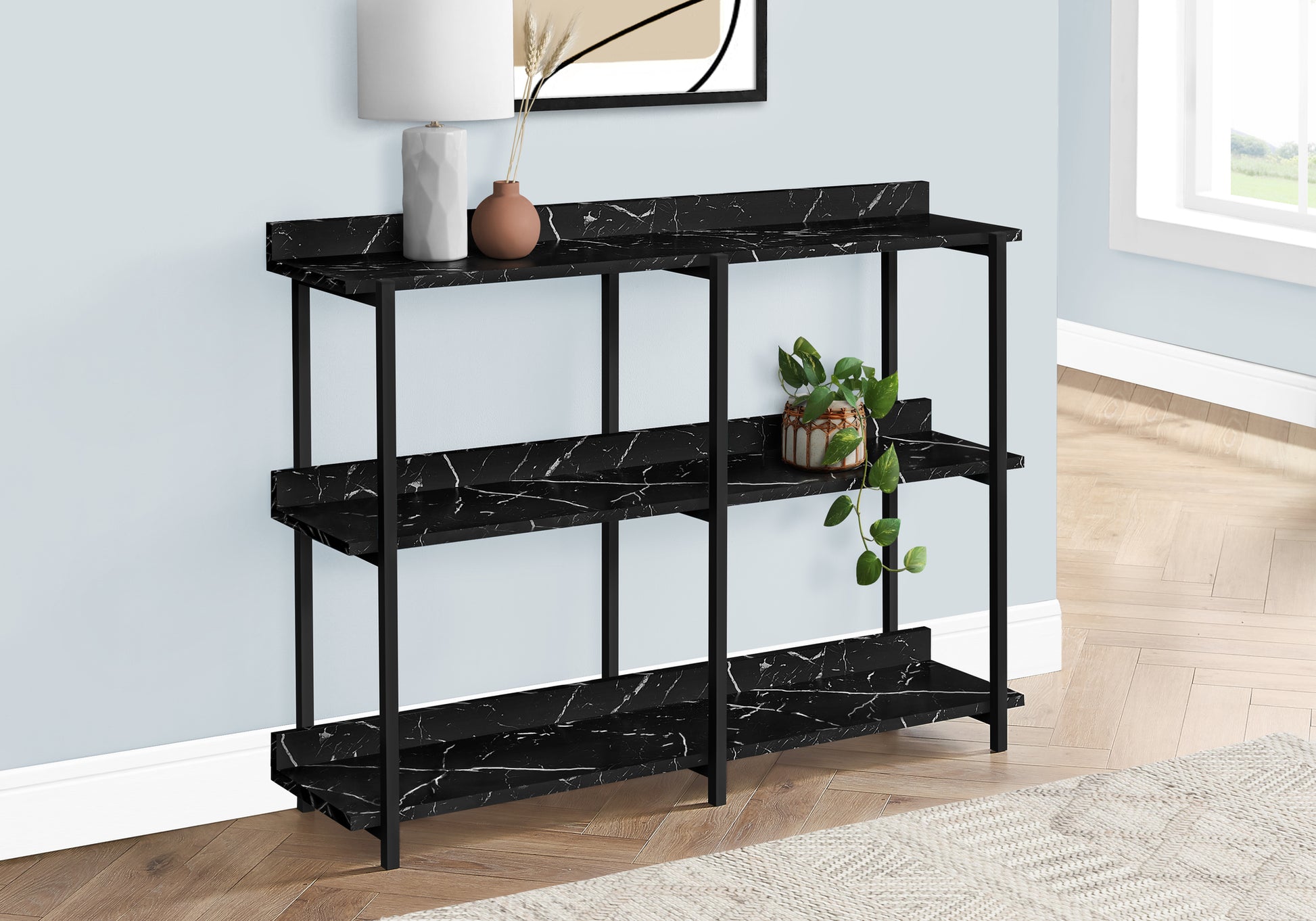 Modern black marble console table with three shelves and black metal frame