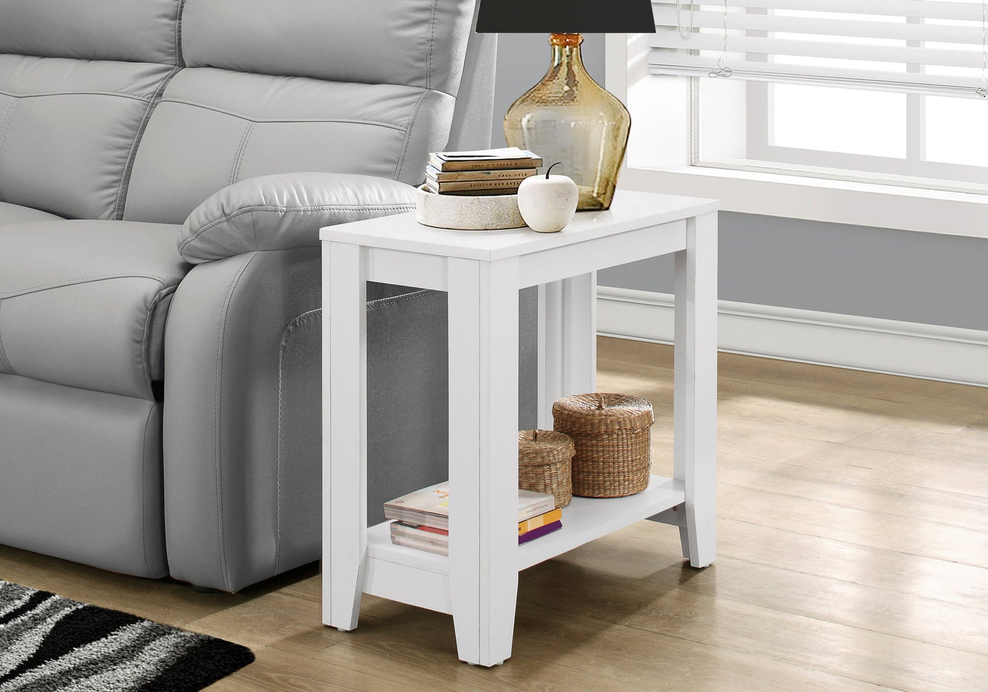 White modern side table with two shelves and decorative items