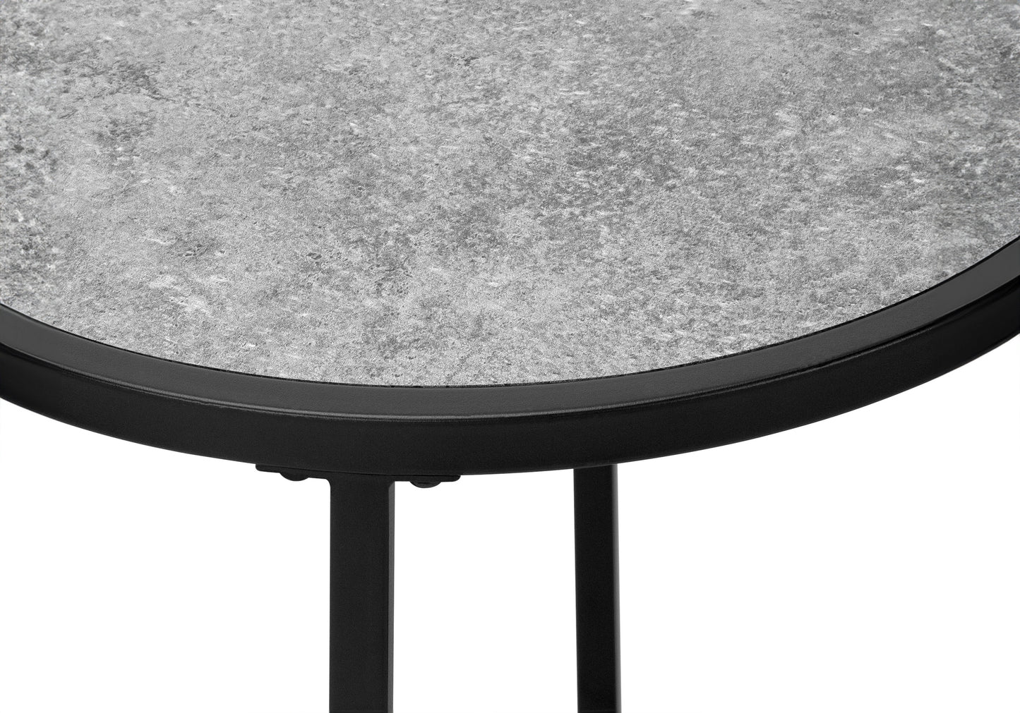 Closeup of a speckled grey textured tabletop with a black metal rim and legs